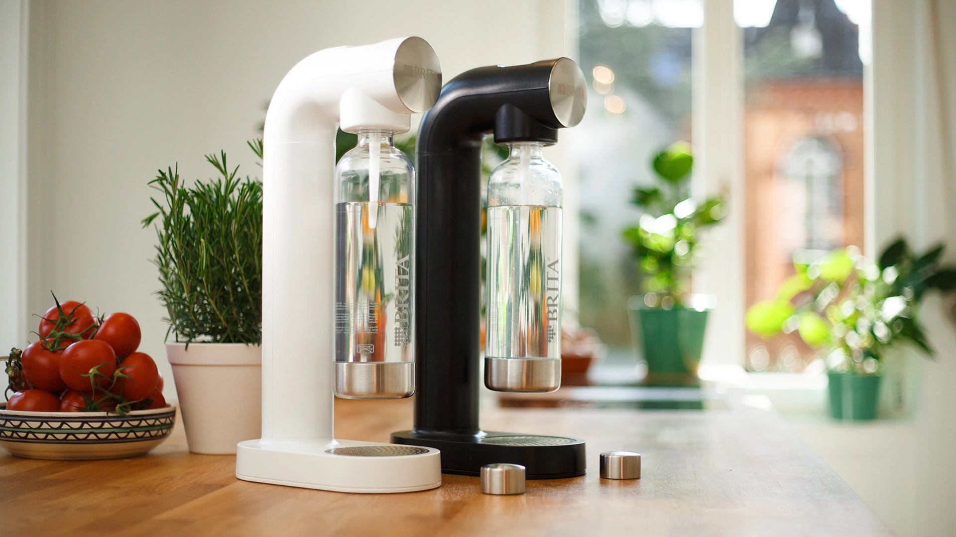 Modern kitchen setup with a white and black BRITA sodaONE on a wooden surface.