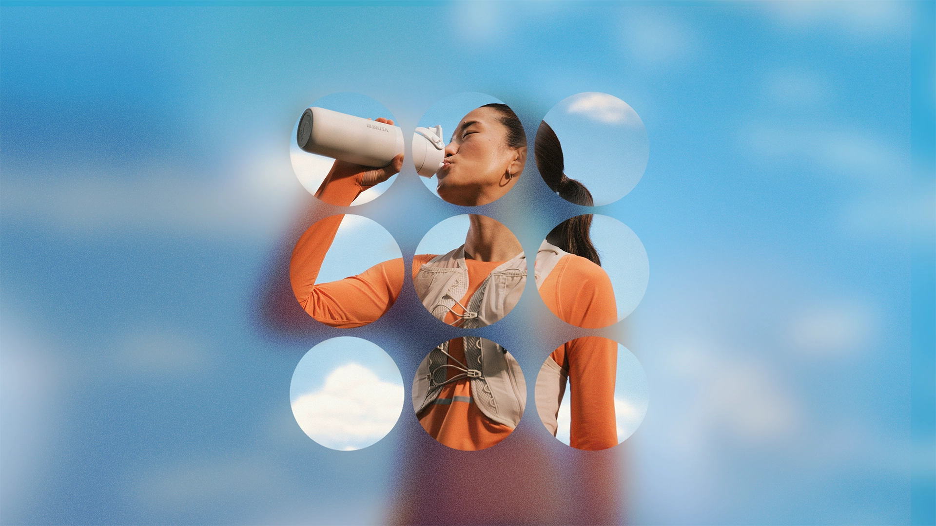 Woman holding a BRITA LARQ water bottle with a blue sky background.