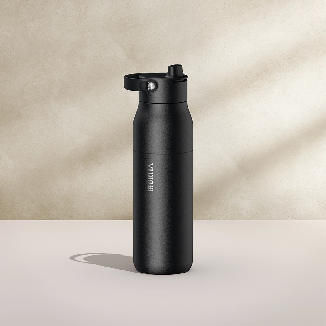 BRITA LARQ Essential Bottle, 1000 ml, in black on a beige background.