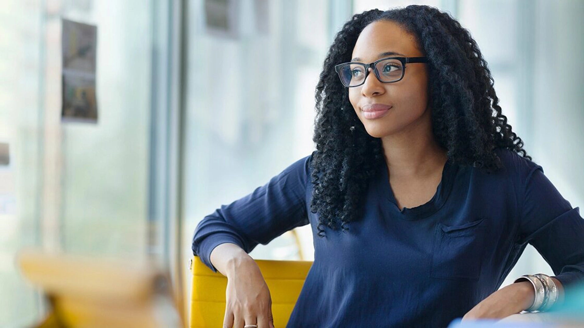 A young woman is smiling with confidence.