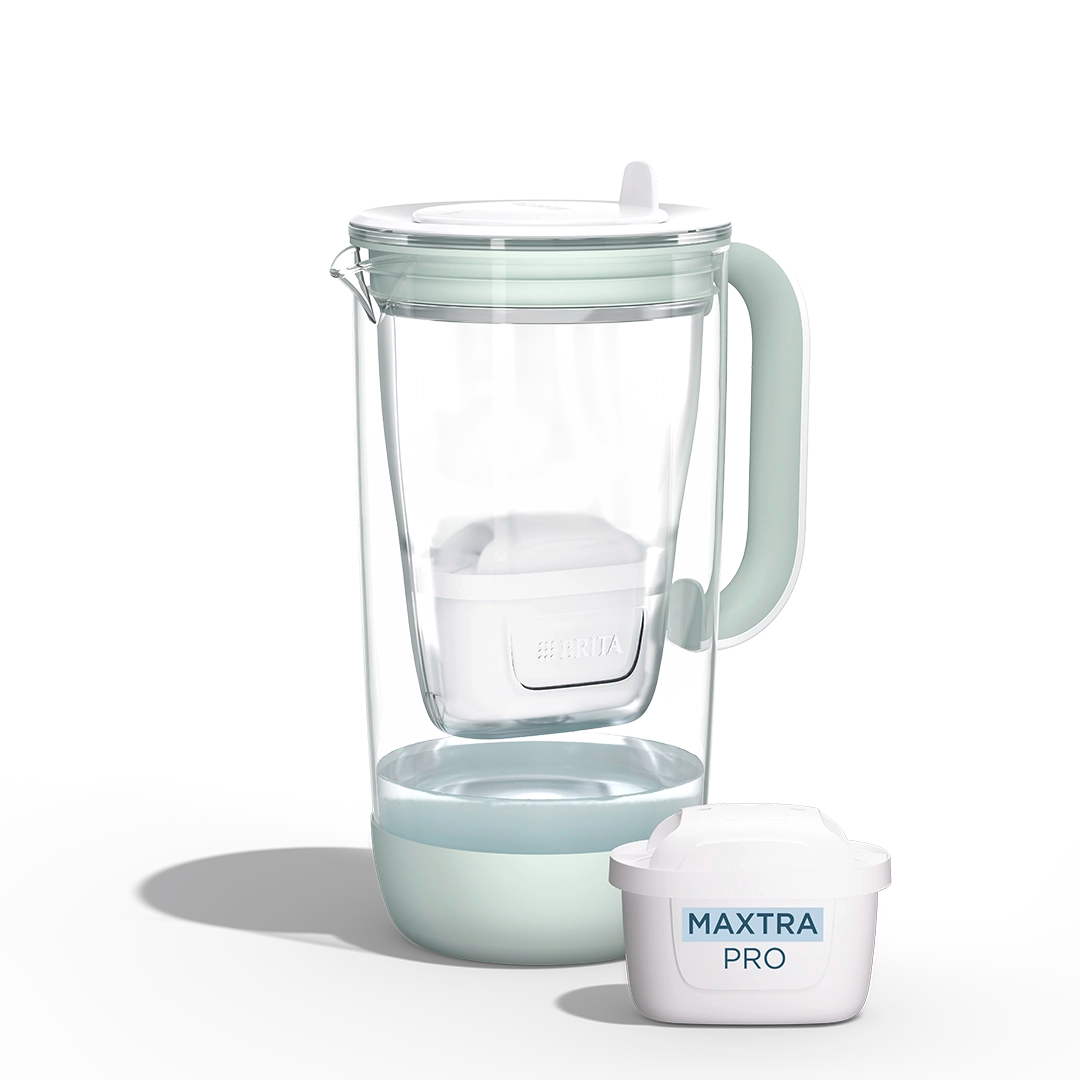 A water filter glass jug in green  on a white background