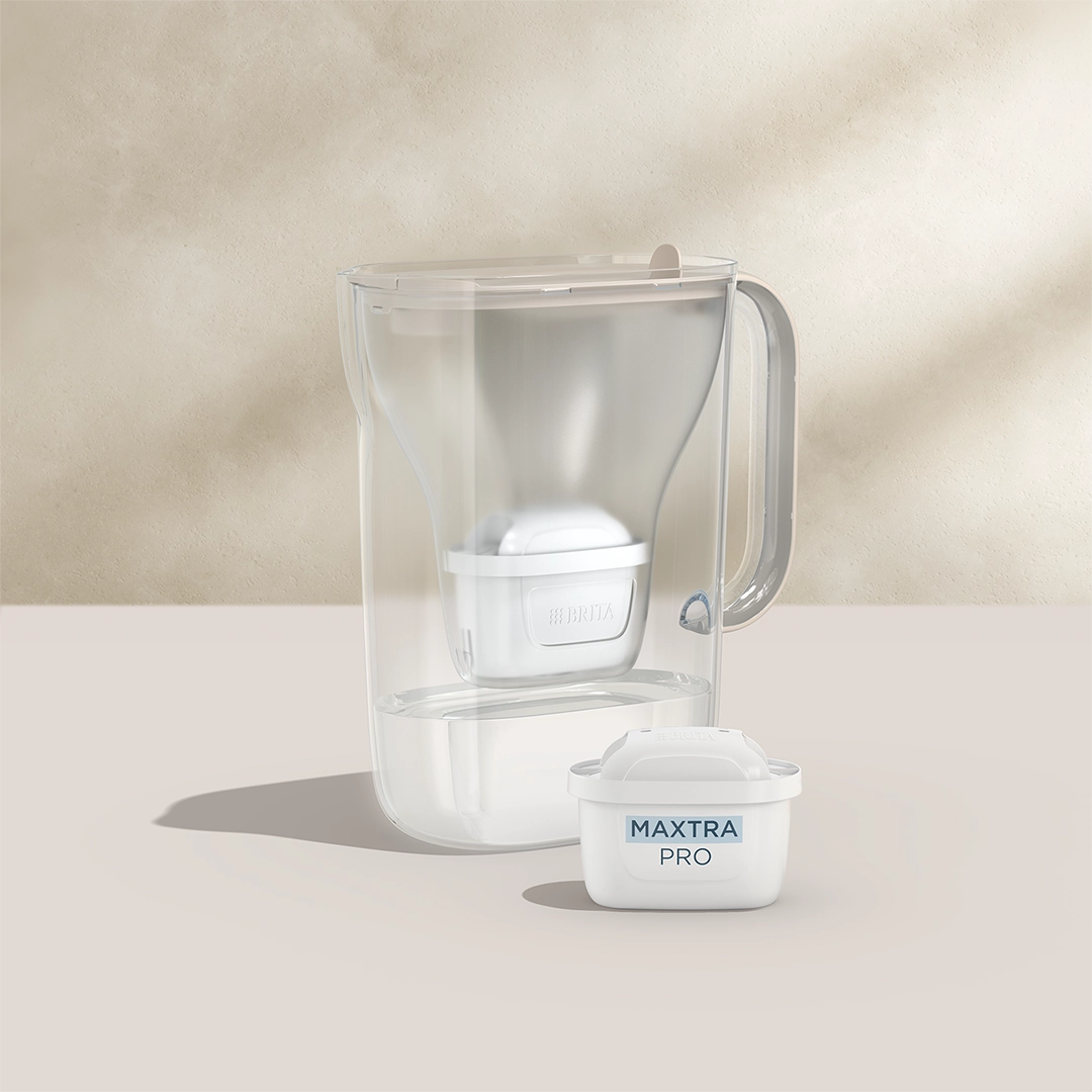 BRITA Style Essential in sand with a MAXTRA PRO filter cartridge on a beige background.
