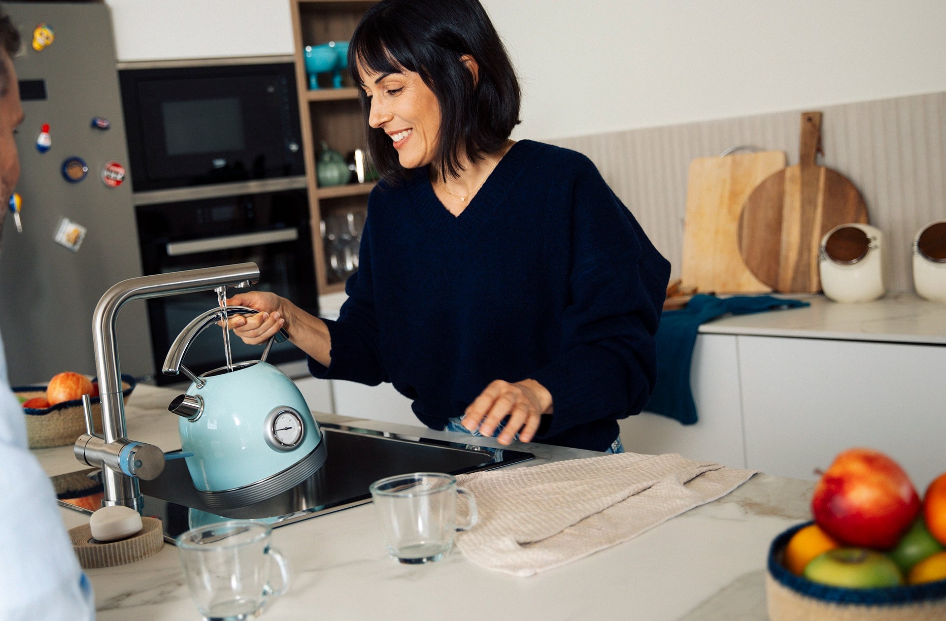 BRITA 3-way rectangular kitchen tap filling a kettle with water.