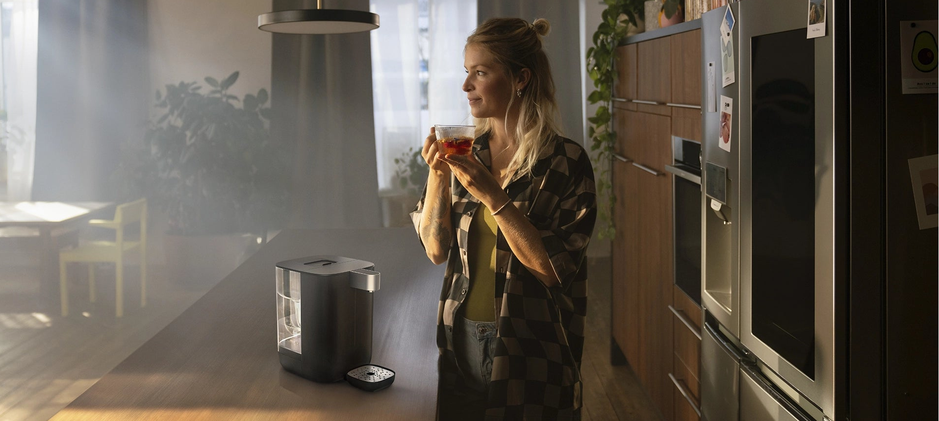 Woman standing next to YOURCE mini on a kitchen counter.
