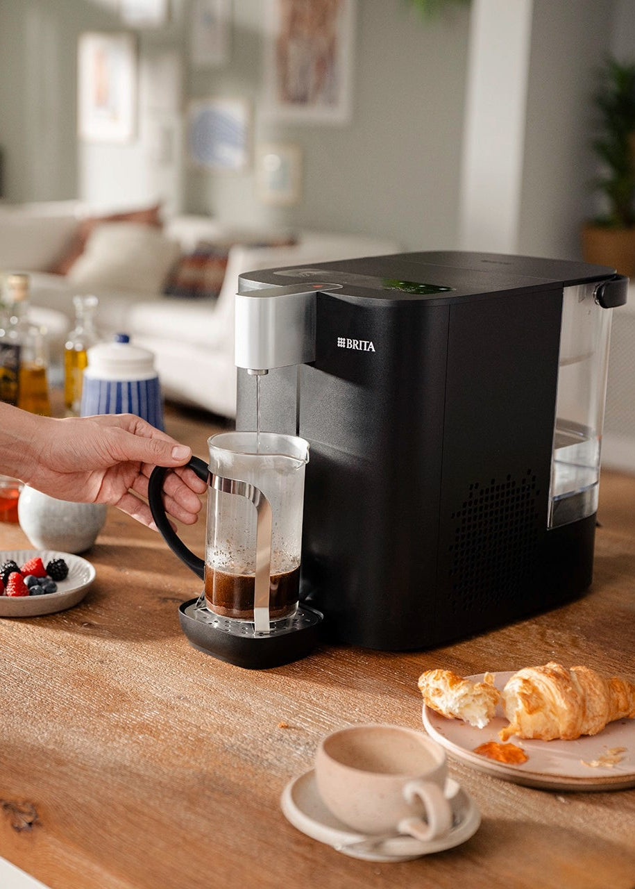 YOURCE cool on a kitchen counter, filling a coffee maker.